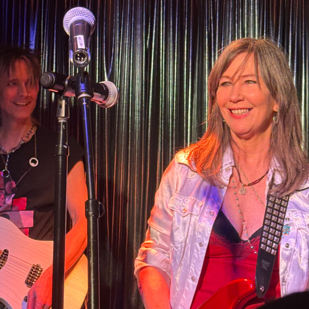 A beaming Kathy Valentine with guitarist Andee Blacksugar.